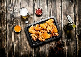 Smoked chicken wings with beer photo