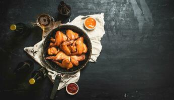 Smoked chicken wings with beer photo