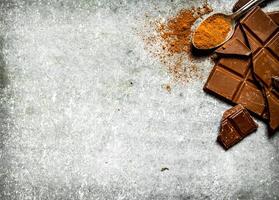 Chocolate with cocoa powder in the spoon. photo