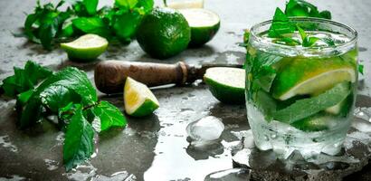 Fresh Mojito with lime and mint on the stone table. photo