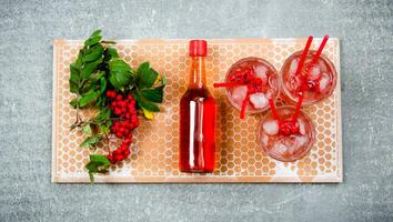 Cocktail with ice and ingredients on a stone tray . photo