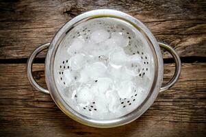 Metal ice bucket for cocktails on a wooden table photo