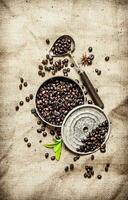 Roasted coffee beans with old tools. photo
