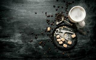 Fresh coffee. Coffee cup with brown sugar and roasted grains . photo