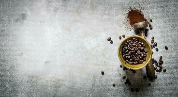 Roasted coffee beans in a mortar with pestle. photo