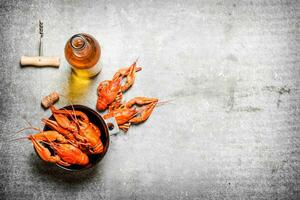 Boiled crawfish with a bottle of white wine photo