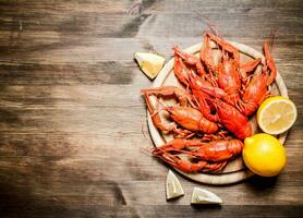 The food delicacies. Boiled crawfish with slices of lemon. photo