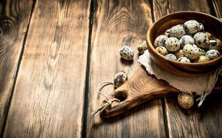 Quail eggs in bowl on the Board. photo