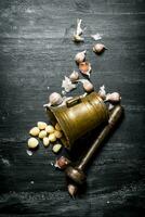 Garlic background. Fresh garlic and a mortar with pestle. photo