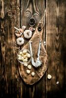 Garlic background . Fresh garlic on old wooden Board. photo