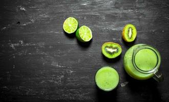 Fresh juice of kiwi and lime in the pitcher. photo