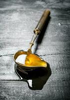 Vintage spoon with natural honey . photo