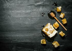 Honey background. Natural honey comb and a wooden spoon . photo