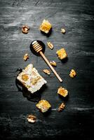 Honey background. Natural honey comb and a wooden spoon . photo