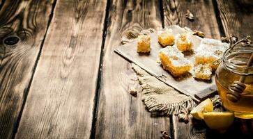 Honey background. Natural honey lemon slices and walnuts. photo