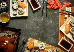 Fragrant tea , sushi and rolls photo