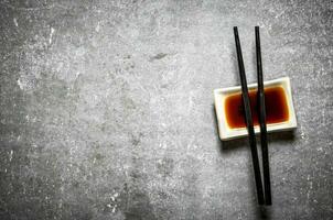 Soy sauce with chopsticks for sushi. photo