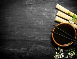 Dry noodles with soy sauce and the cherry branches. photo