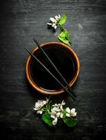 Soy sauce with a blossoming cherry branch. photo