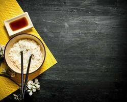 Boiled rice with soy sauce and the cherry branches photo