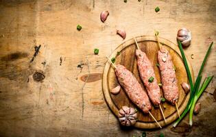 Raw kebab of beef with garlic and onions. photo