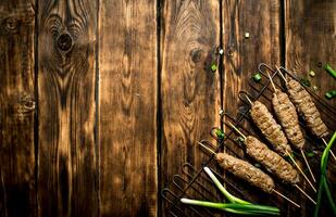 kebab on the grill with green onions. photo