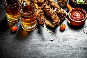 Hot Shish kebab with a cold beer. photo