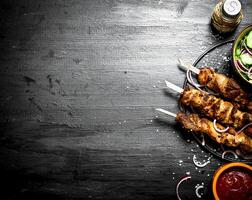 Shish kebab of pork and salad. photo