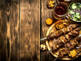 Pork kebab with beer and vegetables. photo