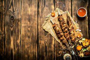 Grilled vegetables with a fragrant Shish kebab from mutton. photo