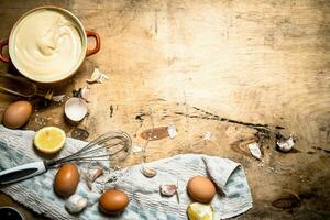 Making mayonnaise from eggs, garlic and lemon. photo