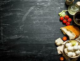 Mozzarella with fresh bread, tomatoes and greens. photo