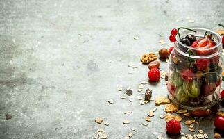 Fitness food. Berries with muesli and nuts. photo