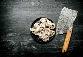Fresh sliced mushrooms with the hatchet. photo