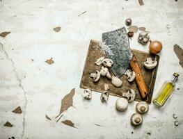 Fresh mushrooms chopped with a hatchet photo