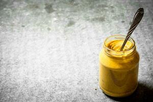 Fresh mustard in a jar photo