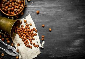 Shelled hazelnuts with Nutcracker and mortar of the old fabric. photo