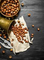 Shelled hazelnuts with Nutcracker and mortar of the old fabric. photo