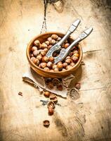 Nuts with Nutcracker in a bowl . photo