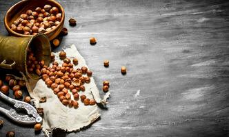 Shelled hazelnuts with Nutcracker and mortar of the old fabric. photo