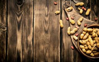 Peanuts in a wooden bowl . photo