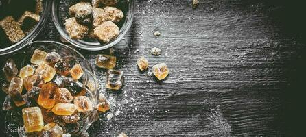 Brown cane sugar. On black rustic background. photo