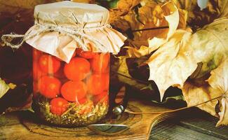 Autumn concept. Preserved food in glass jar photo