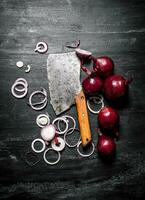 Red onion with an old hatchet. photo