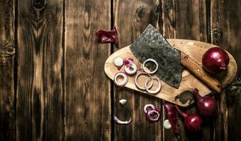 Sliced red onion and an old hatchet. photo