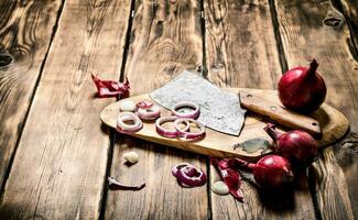 Sliced red onion and an old hatchet. photo