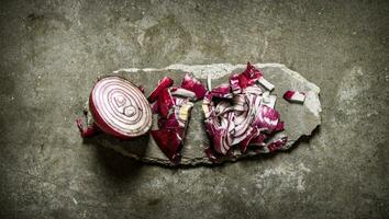 Sliced red onion on a stone stand. photo