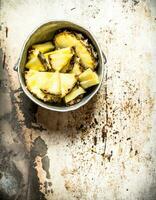 Pineapple chunks in an old pot. photo