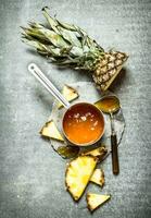 Pineapple jam in a small saucepan. photo