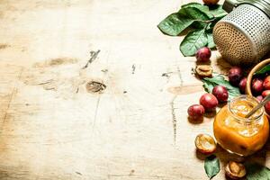 Fresh plum pulp in a glass jar. photo